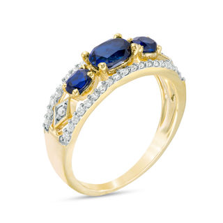 Sideways Oval Lab-Created Blue Sapphire and 0.23 CT. T.W. Diamond Three Stone Ring in 10K Gold|Peoples Jewellers