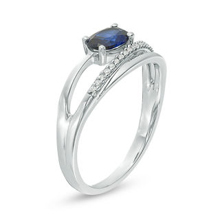Sideways Oval Lab-Created Blue Sapphire and 0.04 CT. T.W. Diamond Crossover Ribbon Promise Ring in Sterling Silver|Peoples Jewellers