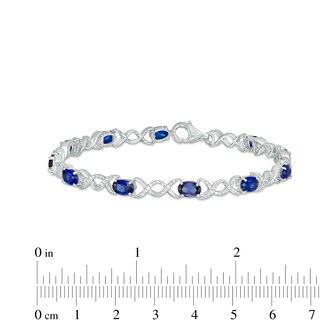 Oval Lab-Created Sapphire and 0.18 CT. T.W. Diamond Infinity Ribbon Link Line Bracelet in Sterling Silver – 7.5"|Peoples Jewellers