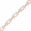 Thumbnail Image 0 of Oval Lab-Created Opal and Diamond Accent Milgrain Bow Bracelet in Sterling Silver with 14K Rose Gold Plate - 7.25"