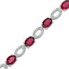 Thumbnail Image 0 of Oval Lab-Created Ruby and Diamond Accent Bracelet in Sterling Silver - 7.5"