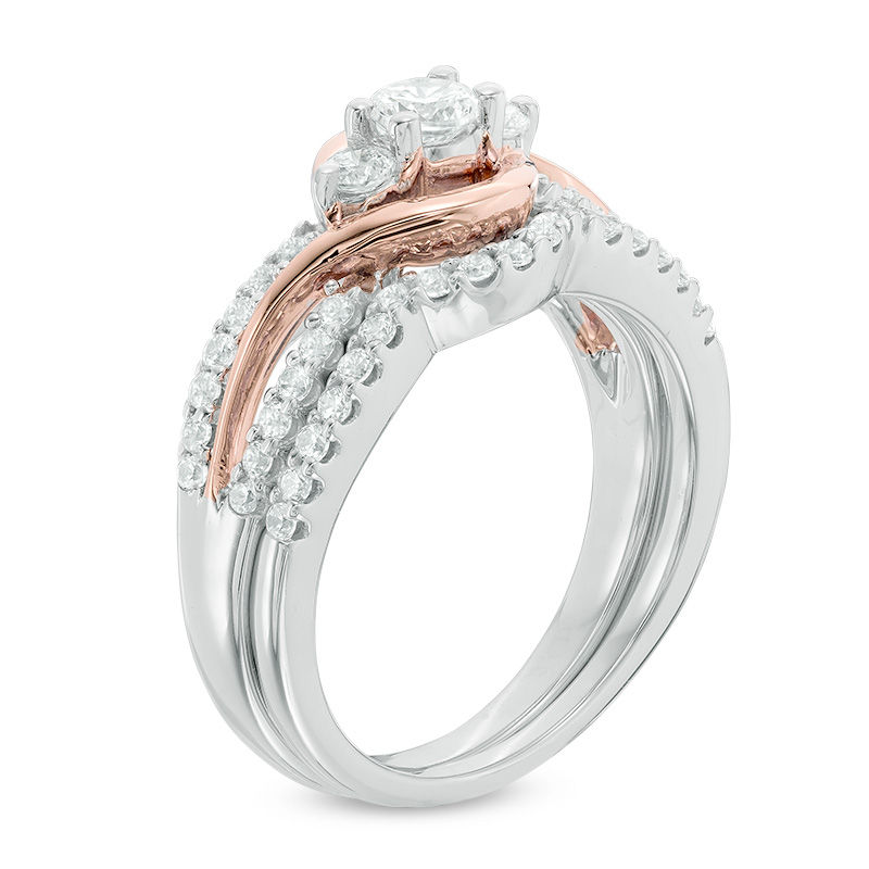 0.70 CT. T.W. Diamond Three Stone Swirl Bridal Set in 10K White Gold