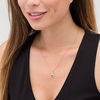 Oval Emerald and 0.25 CT. T.W. Diamond Sunburst Frame Pendant in 10K Gold