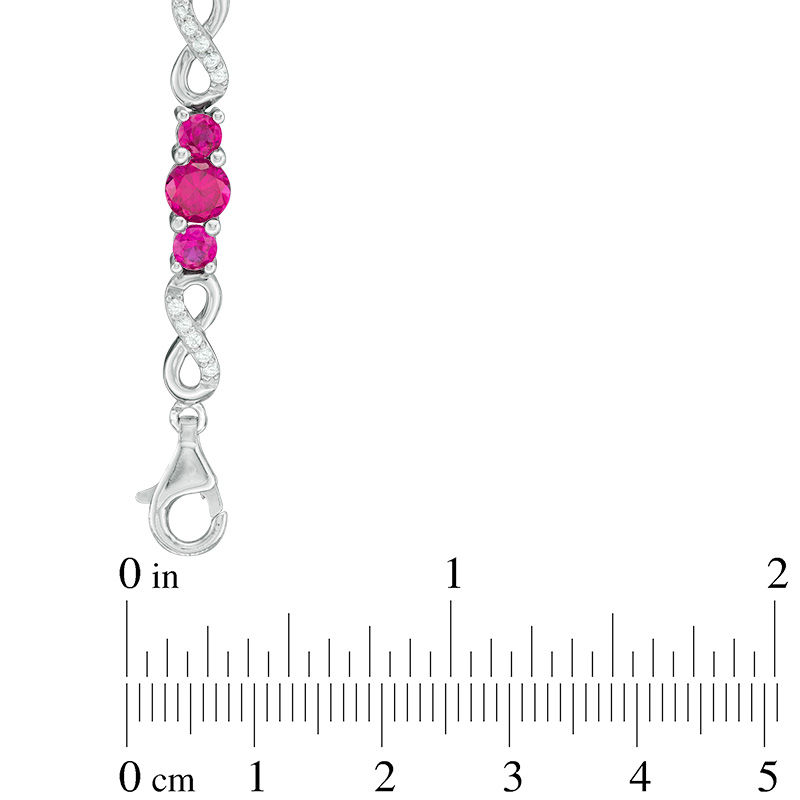 Lab-Created Ruby and White Sapphire Three Stone Infinity Bracelet in Sterling Silver - 7.5"
