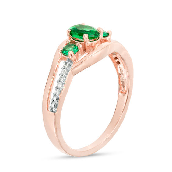 Oval Lab-Created Emerald and 0.04 CT. T.W. Diamond Three Stone Bypass Engagement Ring in 10K Rose Gold