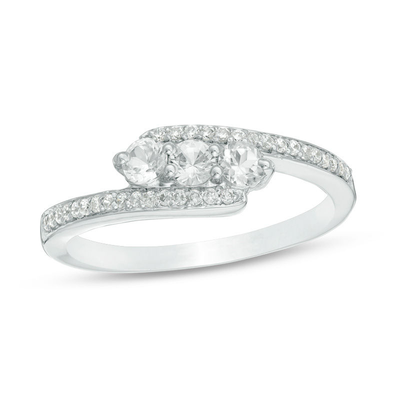Lab-Created White Sapphire and 0.15 CT. T.W. Diamond Three Stone Bypass Ring in Sterling Silver