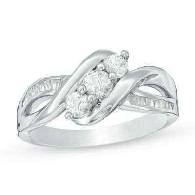 Lab-Created White Sapphire and 0.11 CT. T.W. Baguette Diamond Three Stone Slant Ring in Sterling Silver