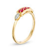 Lab-Created Ruby and Diamond Accent Vintage-Style Three Stone Ring in 10K Gold