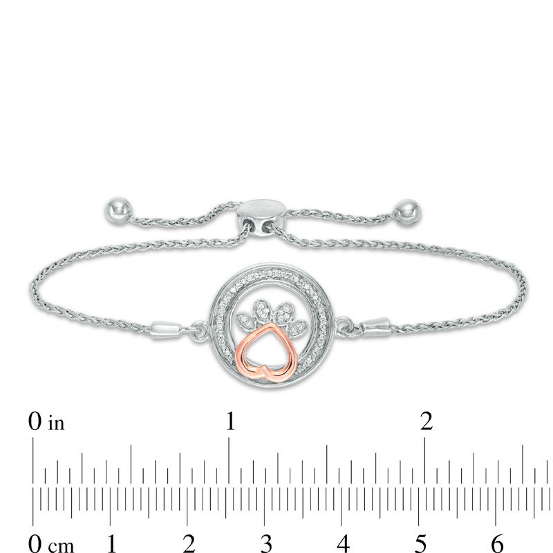 1/15 CT. T.W. Diamond Open Circle with Paw Print Bolo Bracelet in Sterling Silver and 10K Rose Gold (1 Line) - 9.5"|Peoples Jewellers