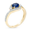 6.0mm Lab-Created Blue Sapphire and 0.23 CT. T.W. Diamond Three Stone Bypass Ring in 10K Gold