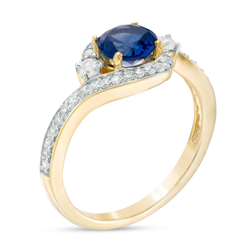 6.0mm Lab-Created Blue Sapphire and 0.23 CT. T.W. Diamond Three Stone Bypass Ring in 10K Gold|Peoples Jewellers