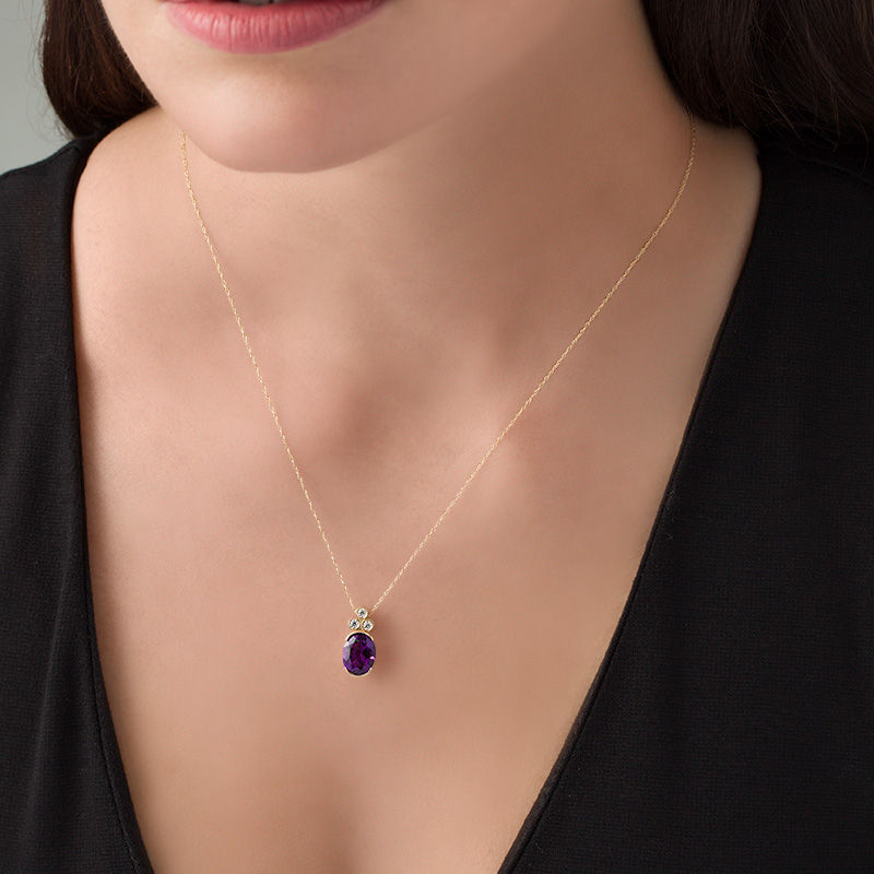 Oval Amethyst and 0.09 CT. T.W. Diamond Tri-Top Pendant in 10K Gold