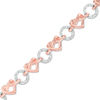 Thumbnail Image 0 of 0.18 CT. T.W. Diamond Love Knot Heart and Open Circle Alternating Bracelet in Sterling Silver and 10K Rose Gold - 7.25"