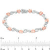 0.115 CT. T.W. Diamond Infinity Heart Bracelet in Sterling Silver and 10K Rose Gold