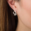 Thumbnail Image 1 of 0.146 CT. T.W. Diamond Swirl Ribbon Vintage-Style Hoop Earrings in Sterling Silver