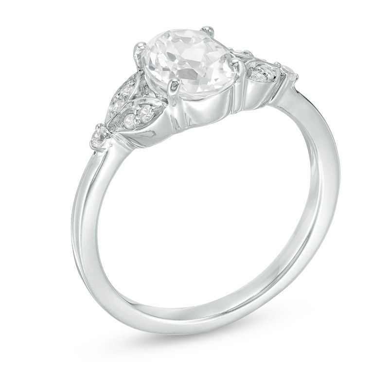 Oval Lab-Created White Sapphire and 0.086 CT. T.W. Diamond Leaf Sides Ring in Sterling Silver|Peoples Jewellers