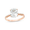 Thumbnail Image 0 of Oval Lab-Created White Sapphire and 0.04 CT. T.W. Diamond Ring in 10K Rose Gold