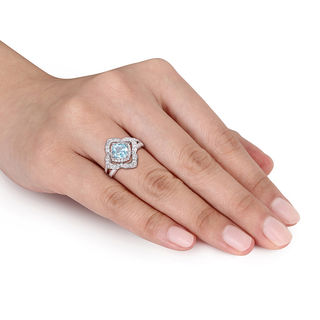 6.0mm Cushion-Cut Blue Topaz and 0.19 CT. T.W. Diamond Flower Frame Split Shank Ring in Sterling Silver