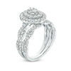 0.69 CT. T.W. Oval Multi-Diamond Double Frame Twist Bridal Set in 10K White Gold