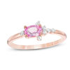 Thumbnail Image 0 of Oval Lab-Created Pink Sapphire and 0.065 CT. T.W. Diamond Side Accent Promise Ring in 10K Rose Gold