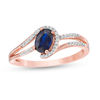 Thumbnail Image 0 of Oval Lab-Created Blue Sapphire and 0.065 CT. T.W. Diamond Swirling Bypass Split Shank Promise Ring in 10K Rose Gold