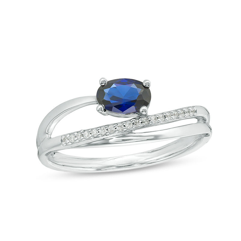 Sideways Oval Lab-Created Blue Sapphire and 0.04 CT. T.W. Diamond Crossover Ribbon Promise Ring in Sterling Silver|Peoples Jewellers