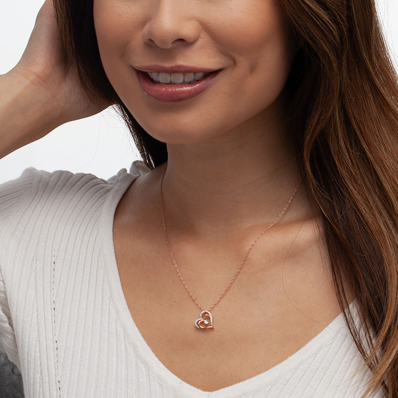 0.085 CT. T.W. Diamond Tilted Layered Double Heart Pendant in 10K Rose Gold|Peoples Jewellers