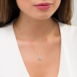 Pear-Shaped Swiss Blue Topaz and 0.15 CT. T.W. Diamond Scallop Frame Ornate Pendant in 10K Gold