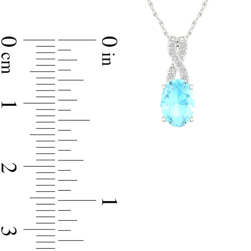 Oval Aquamarine and 0.04 CT. T.W. Diamond "X" Drop Pendant in 10K White Gold