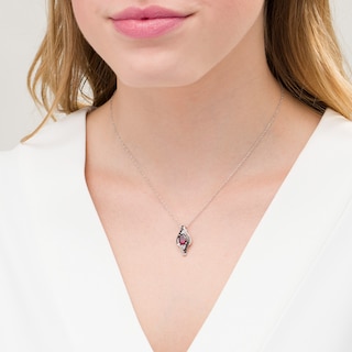 Oval Garnet and 0.085 CT. T.W. White and Black Diamond Bypass Frame Pendant in Sterling Silver