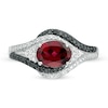 Oval Garnet and 0.085 CT. T.W. White and Black Diamond Bypass Frame Ring in Sterling Silver