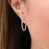 0.25 CT. T.W. Diamond Inside-Out Hoop Earrings in Sterling Silver with 10K Gold Plate