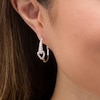 Thumbnail Image 1 of Love + Be Loved 0.50 CT. T.W. Diamond Interlocking Loop Hoop Earrings in 10K White Gold