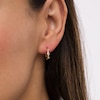 Thumbnail Image 1 of Cubic Zirconia Three Stone Twisted Loose Braid Huggie Hoop Earrings in 14K Gold