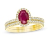 Oval Ruby and 0.33 CT. T.W. Diamond Frame Bridal Set in 14K Gold