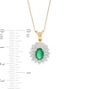 Oval Emerald and 0.20 CT. T.W. Diamond Flower Frame Pendant in 10K Gold