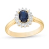 Oval Blue Sapphire and 0.20 CT. T.W. Baguette and Round Diamond Starburst Frame Ring in 10K Gold