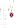 Oval Ruby and 0.20 CT. T.W. Baguette and Round Diamond Starburst Frame Pendant in 10K Gold