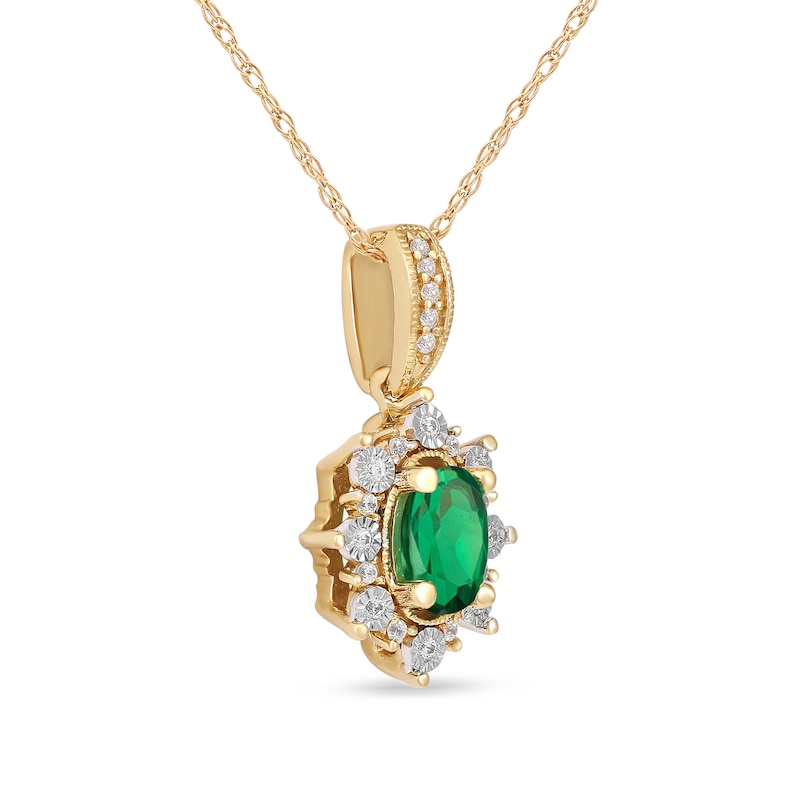 Oval Emerald and 0.08 CT. T.W. Diamond Sunburst Frame Vintage-Style Drop Pendant in 10K Gold