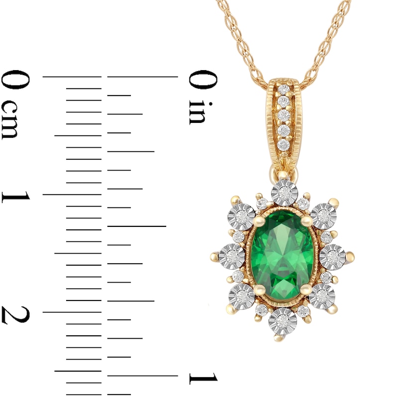 Oval Emerald and 0.08 CT. T.W. Diamond Sunburst Frame Vintage-Style Drop Pendant in 10K Gold