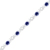 Thumbnail Image 0 of 5.0mm Lab-Created Blue Sapphire and 0.09 CT. T.W. Diamond "MOM" Looping Ribbon Bracelet in Sterling Silver - 7.5"