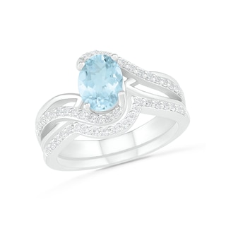 Oval Aquamarine and 0.086 CT. T.W. Diamond Bypass Split Shank Bridal Set in Sterling Silver