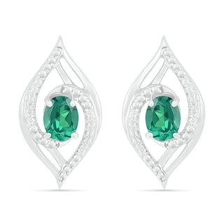 Lab-Created Oval Emerald and 0.067 CT. T.W. Diamond Bypass Flame Stud Earrings in Sterling Silver