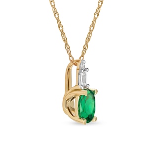 Oval Emerald and 0.05 CT. T.W. Baguette and Round Diamond Stacked Top Accent Pendant in 10K Gold