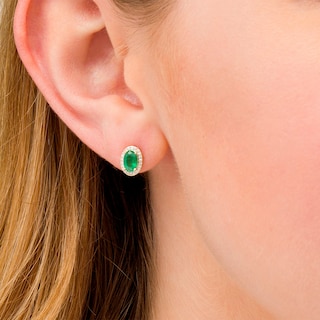 Oval Emerald and 0.088 CT. T.W. Diamond Frame Stud Earrings in 10K Gold