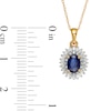 Oval Blue Sapphire and 0.19 CT. T.W. Baguette and Round Diamond Double Frame Floral Drop Pendant in 10K Gold