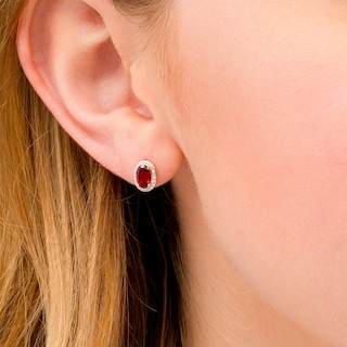 Oval Garnet and 0.088 CT. T.W. Diamond Frame Stud Earrings in 10K Gold