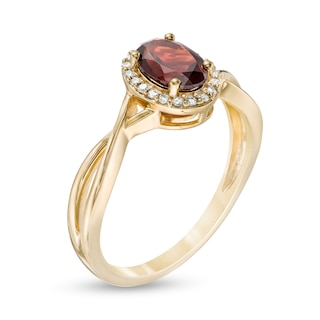 Oval Garnet and 0.08 CT. T.W. Diamond Frame Twist Shank Ring in 10K Gold