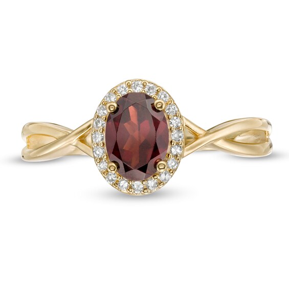 Oval Garnet and 0.08 CT. T.W. Diamond Frame Twist Shank Ring in 10K Gold