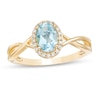 Thumbnail Image 0 of Oval Swiss Blue Topaz and 0.08 CT. T.W. Diamond Frame Twist Shank Ring in 10K Gold
